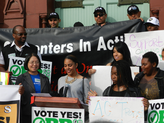 Mary Lim-Lampe, Lead Organizer with the faith-based group, Genesis listens as Alicia Oliver, a Sophomore at Emiliano Zapata Street Academy talks about the importance of affordable bus service for youth.