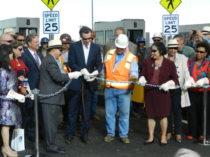 Elected officials, construction workers and Caltrans staff watched as Lieutenant Governor Gavin Newsom wielded an acetylene torch for the chain-cutting ceremony that opened the new East Span of the Bay Bridge on Labor Day.